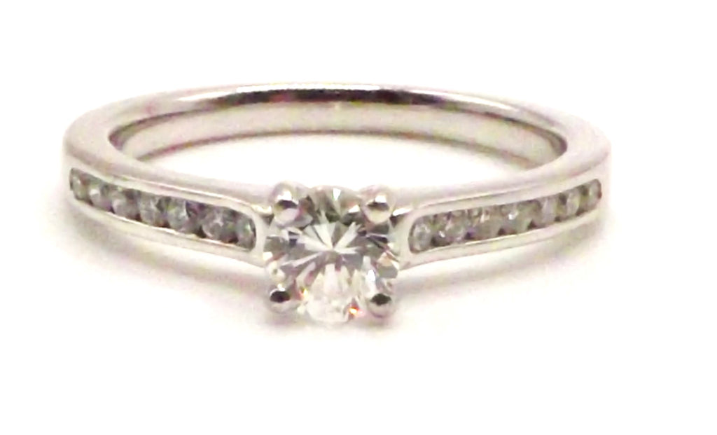 Platinum  ring set with 0.51 ct diamond surrounded by 0.26 ct diamonds