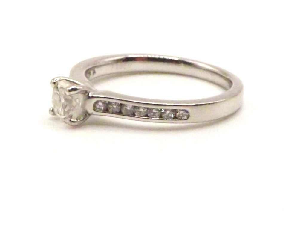 Platinum  ring set with 0.51 ct diamond surrounded by 0.26 ct diamonds